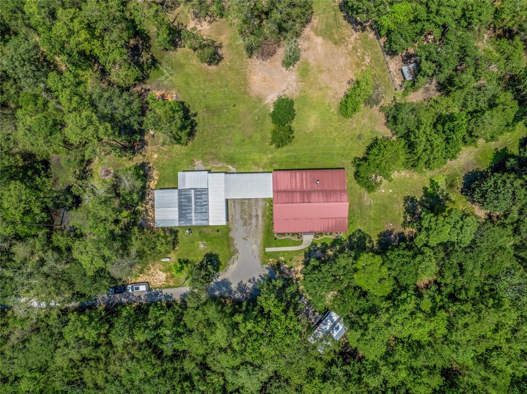 Aerial view directly over main home! The majority of this 12+ AC property is fully wooded for privacy!