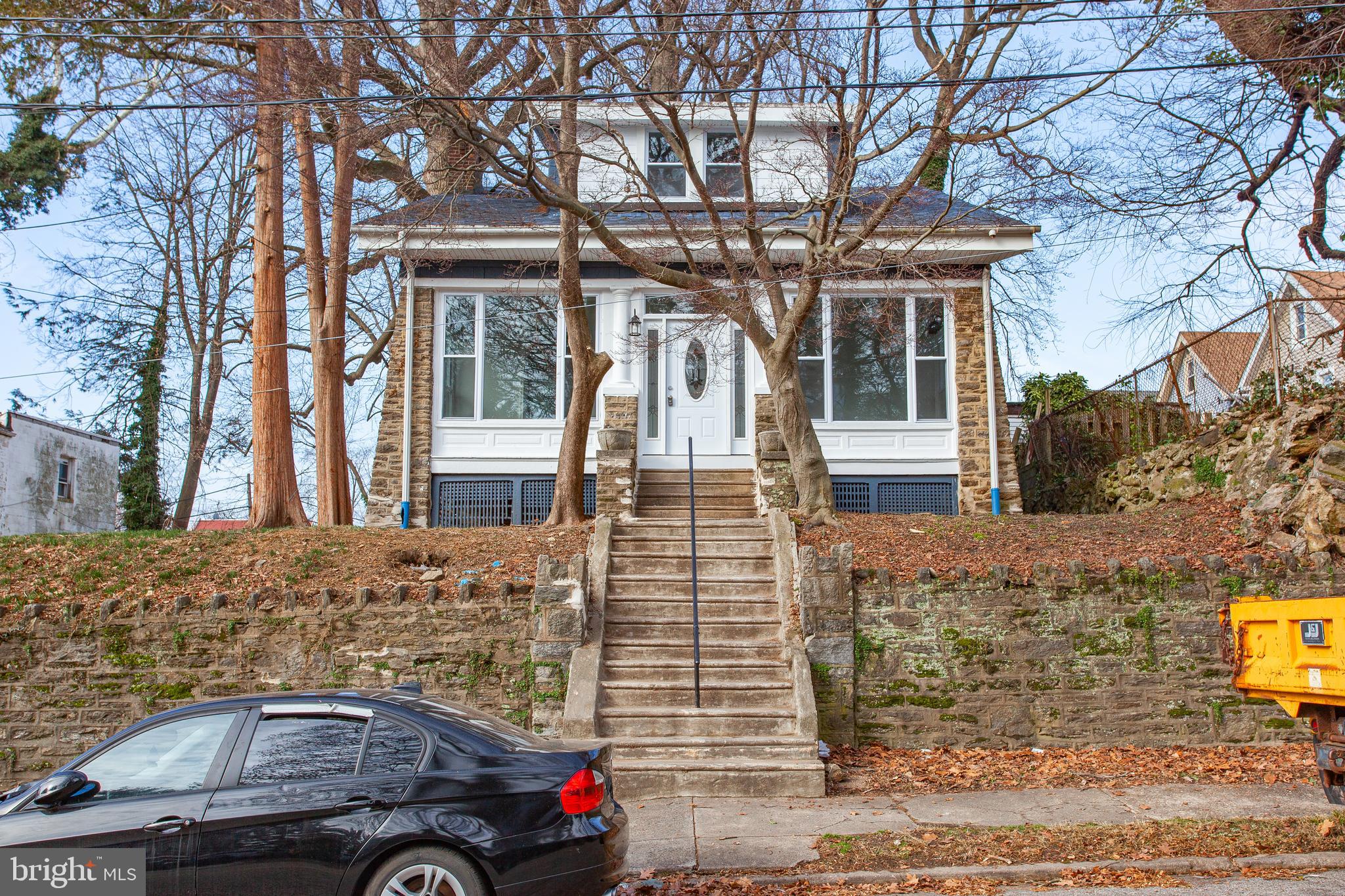 front view of a house with a cars parked