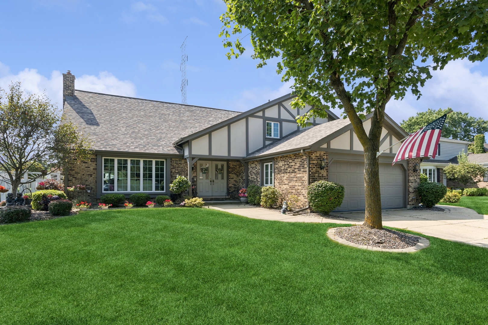 a front view of a house with a yard and trees