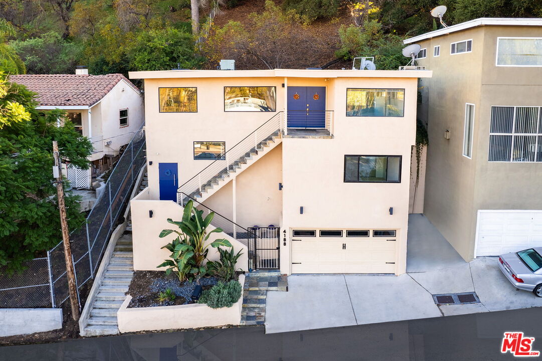 an aerial view of residential houses with outdoor space and street view