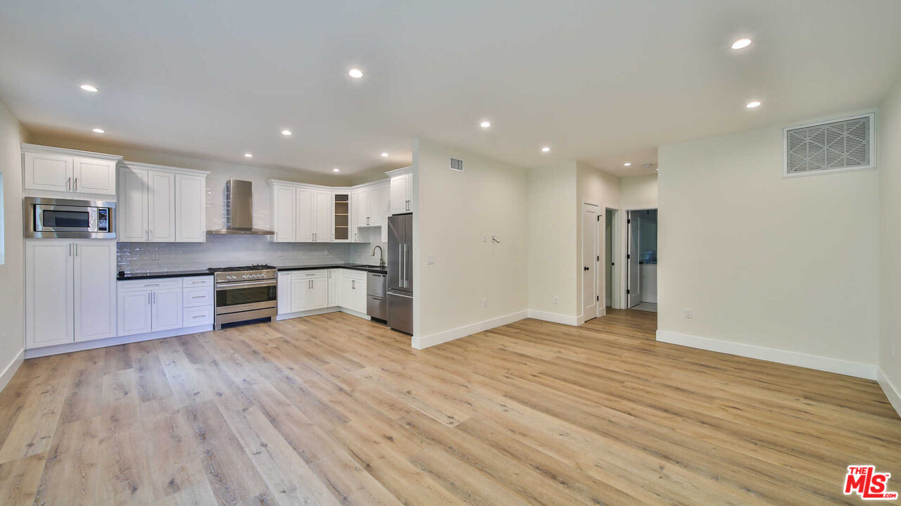 a view of kitchen with wooden floor