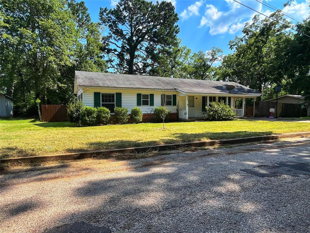 a view of a house with swimming pool and a yard