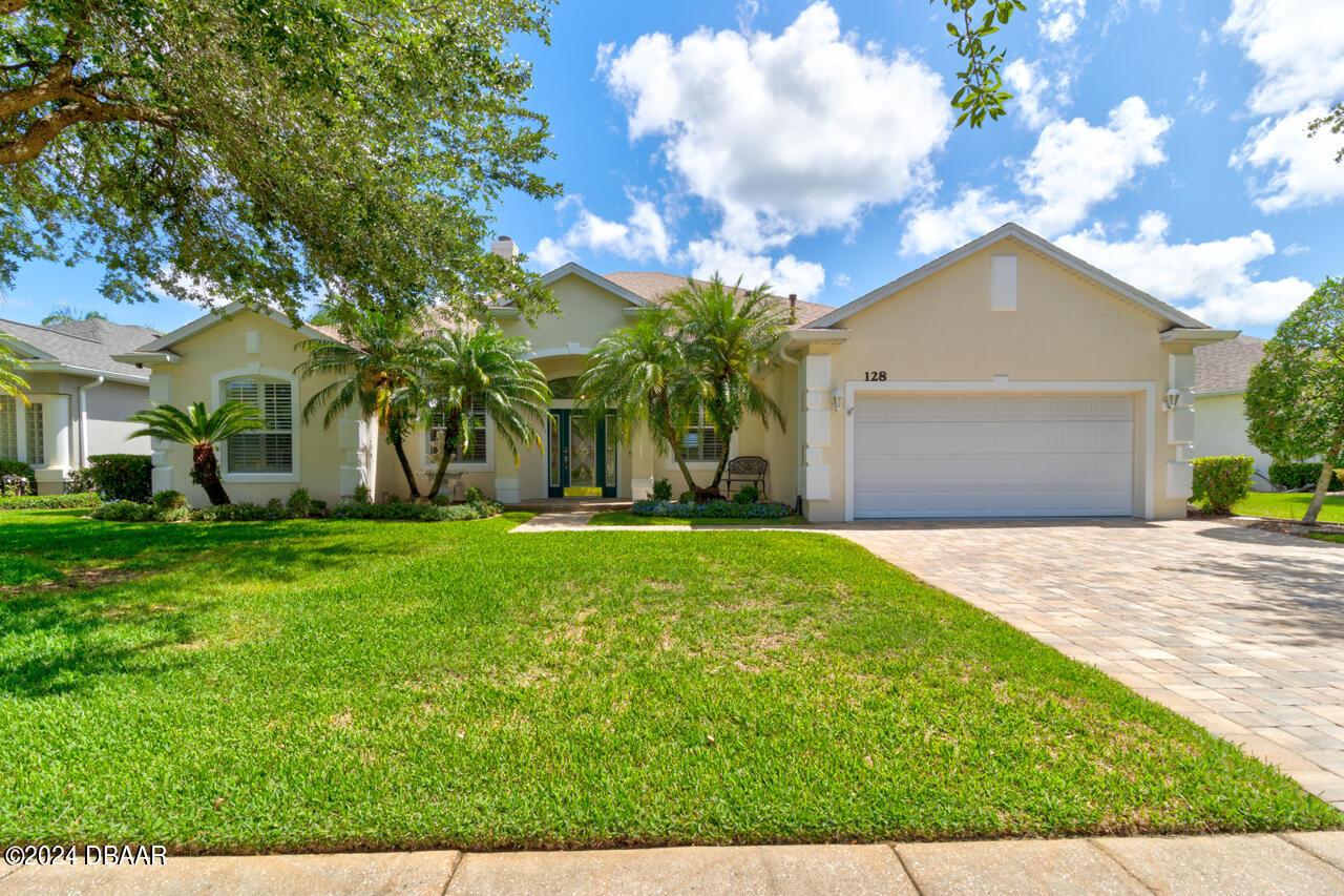 a front view of house with yard and green space