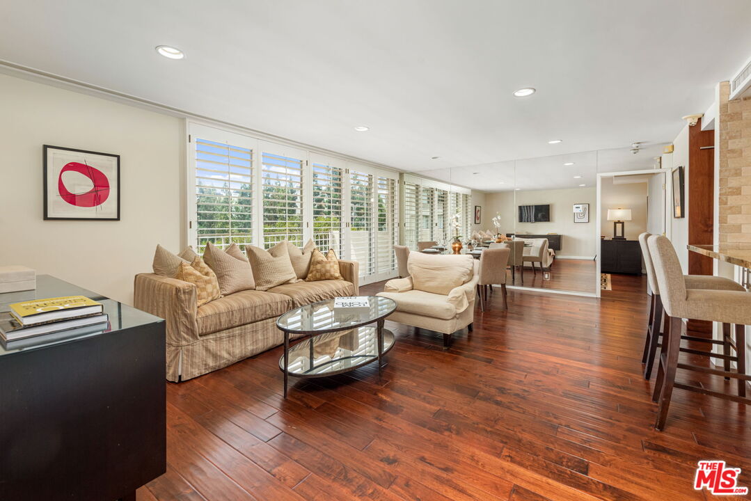 a living room with fireplace furniture and a wooden floor