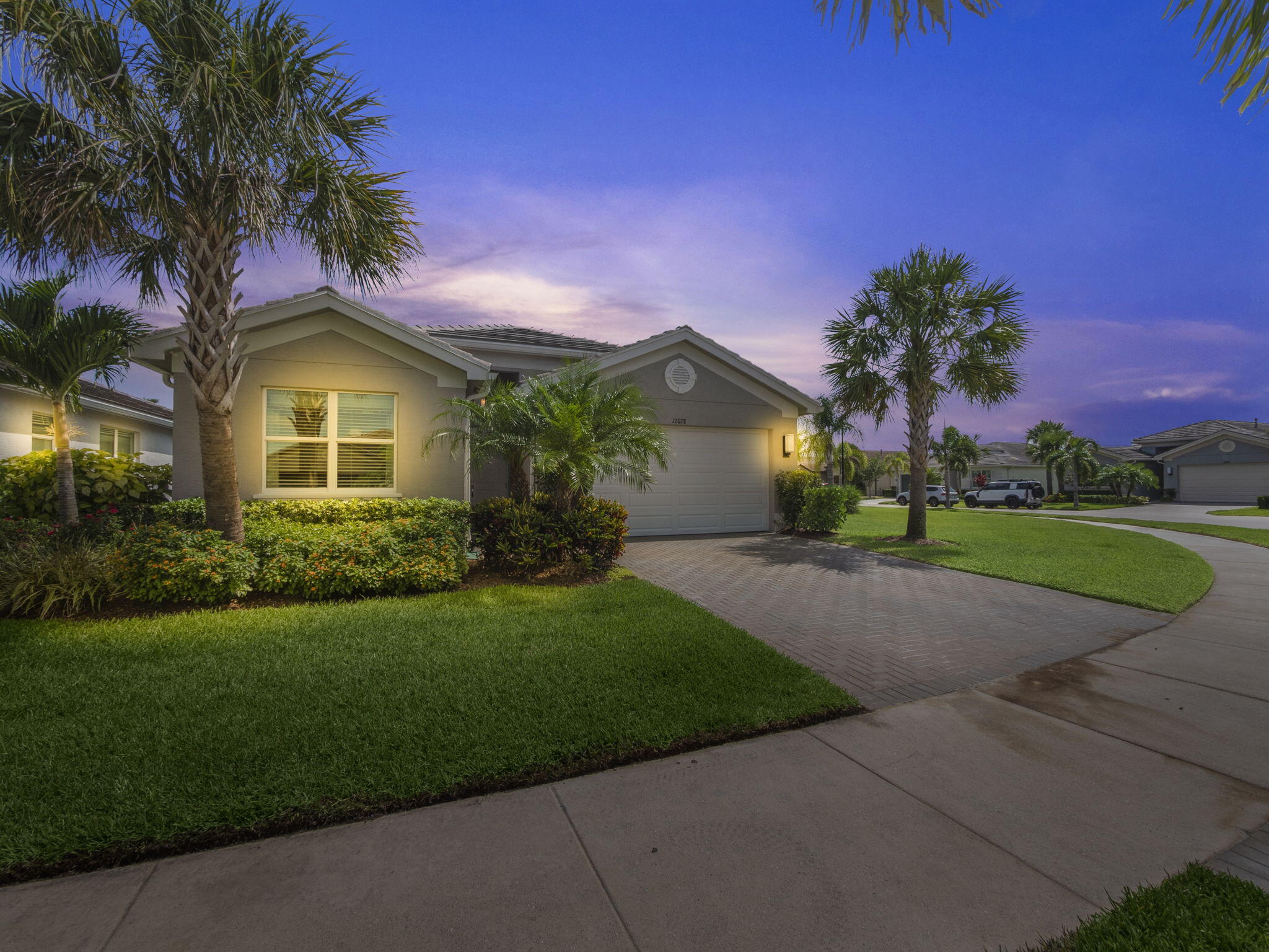 a front view of a house with a garden and yard