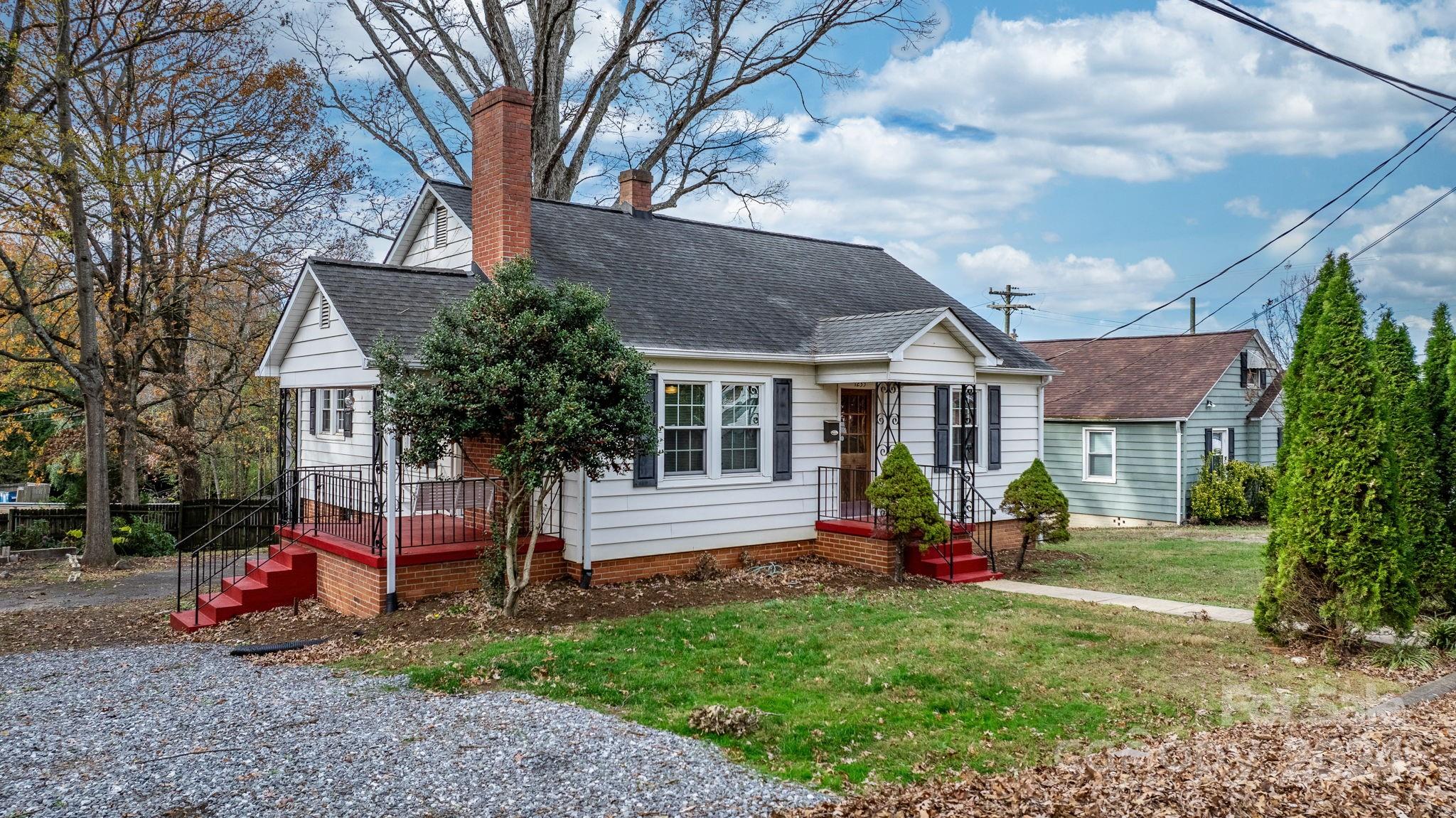 a view of a house with a yard porch and sitting area