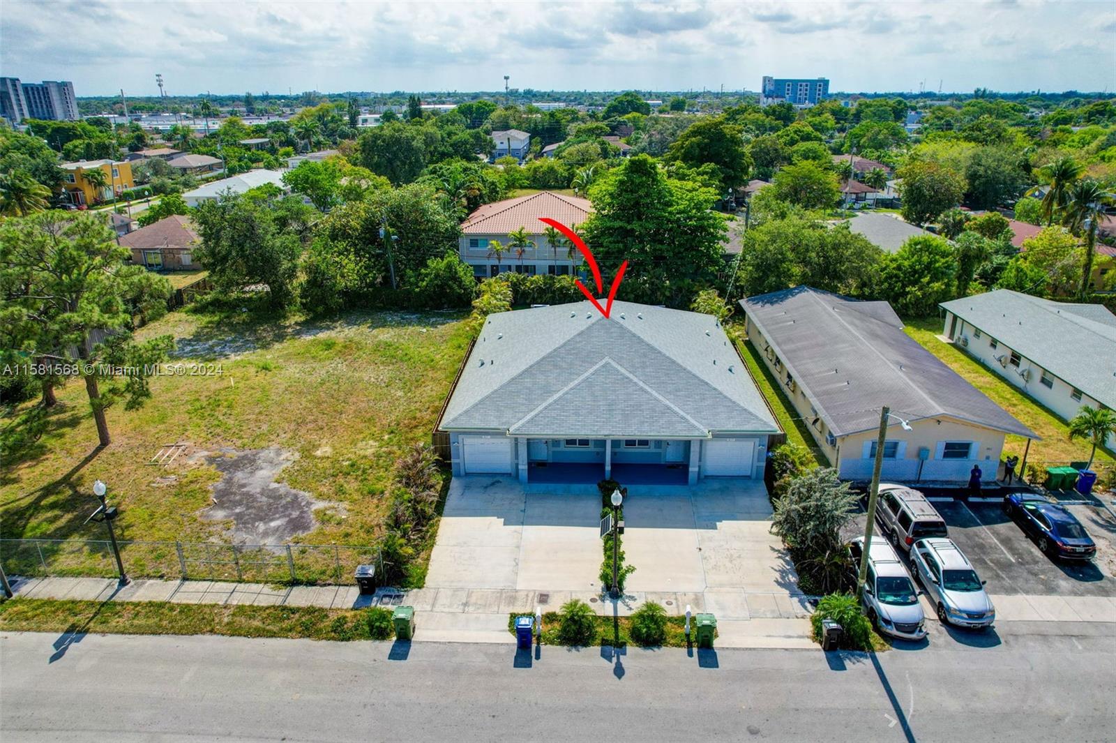 a aerial view of a house with a yard and potted plants