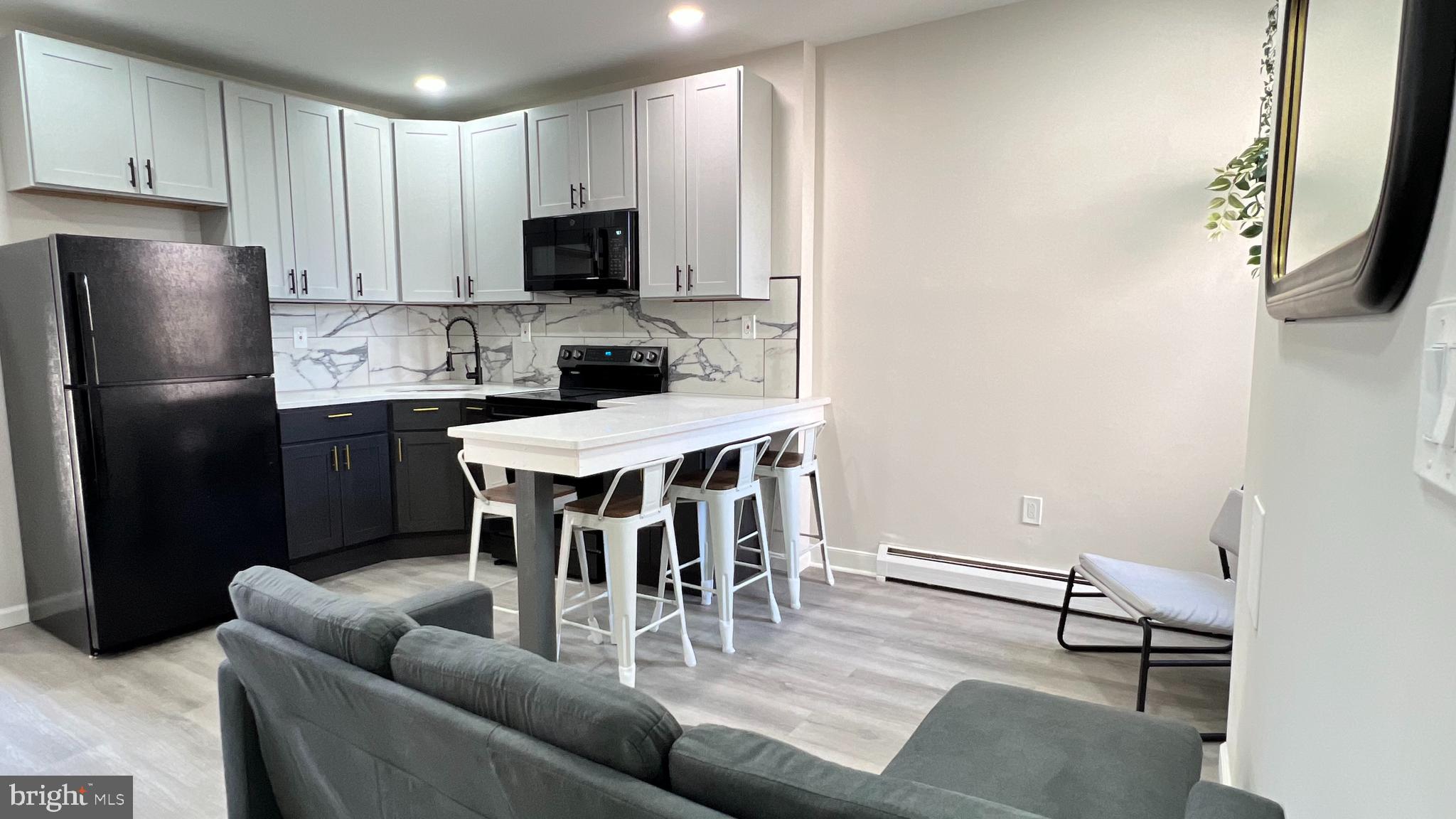 a dining room with furniture and a kitchen view