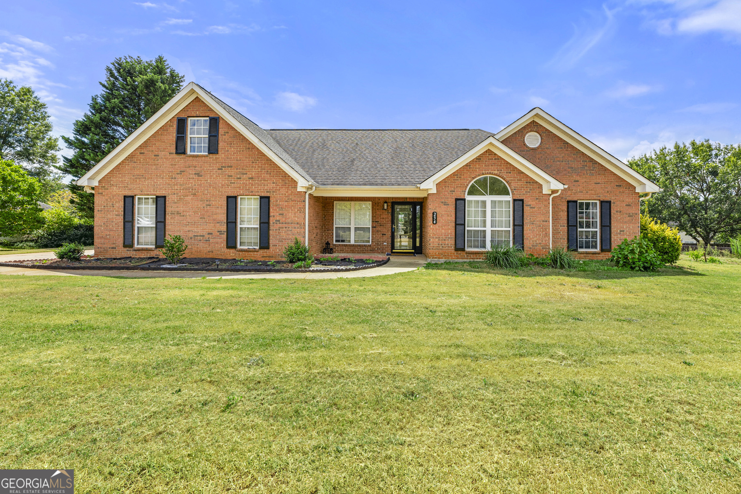 a front view of house with yard and green space