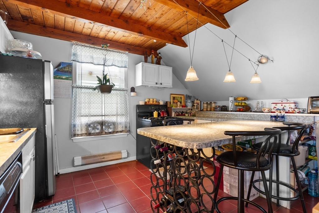 a kitchen with a table and chairs