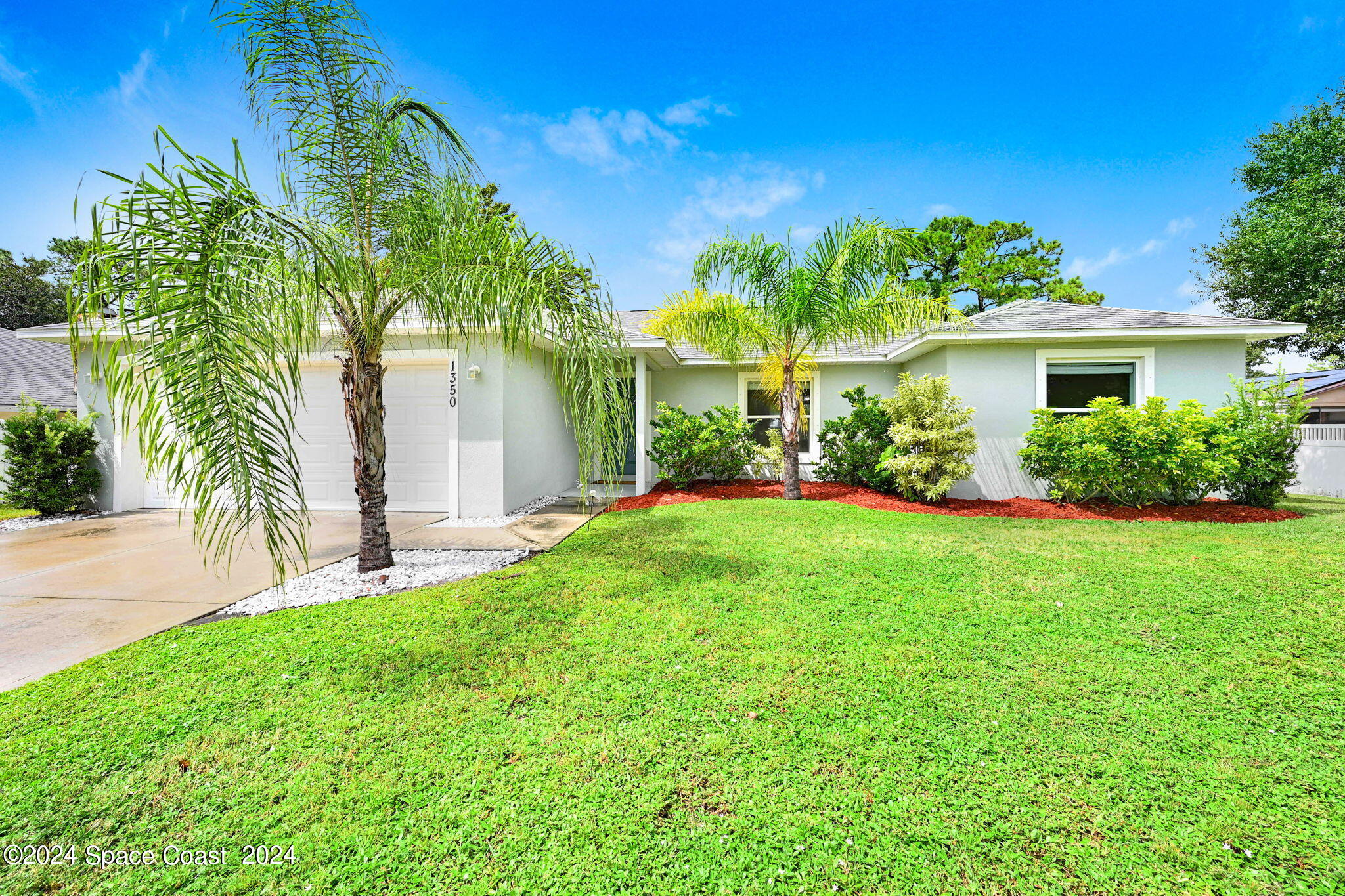 a front view of house with yard and green space