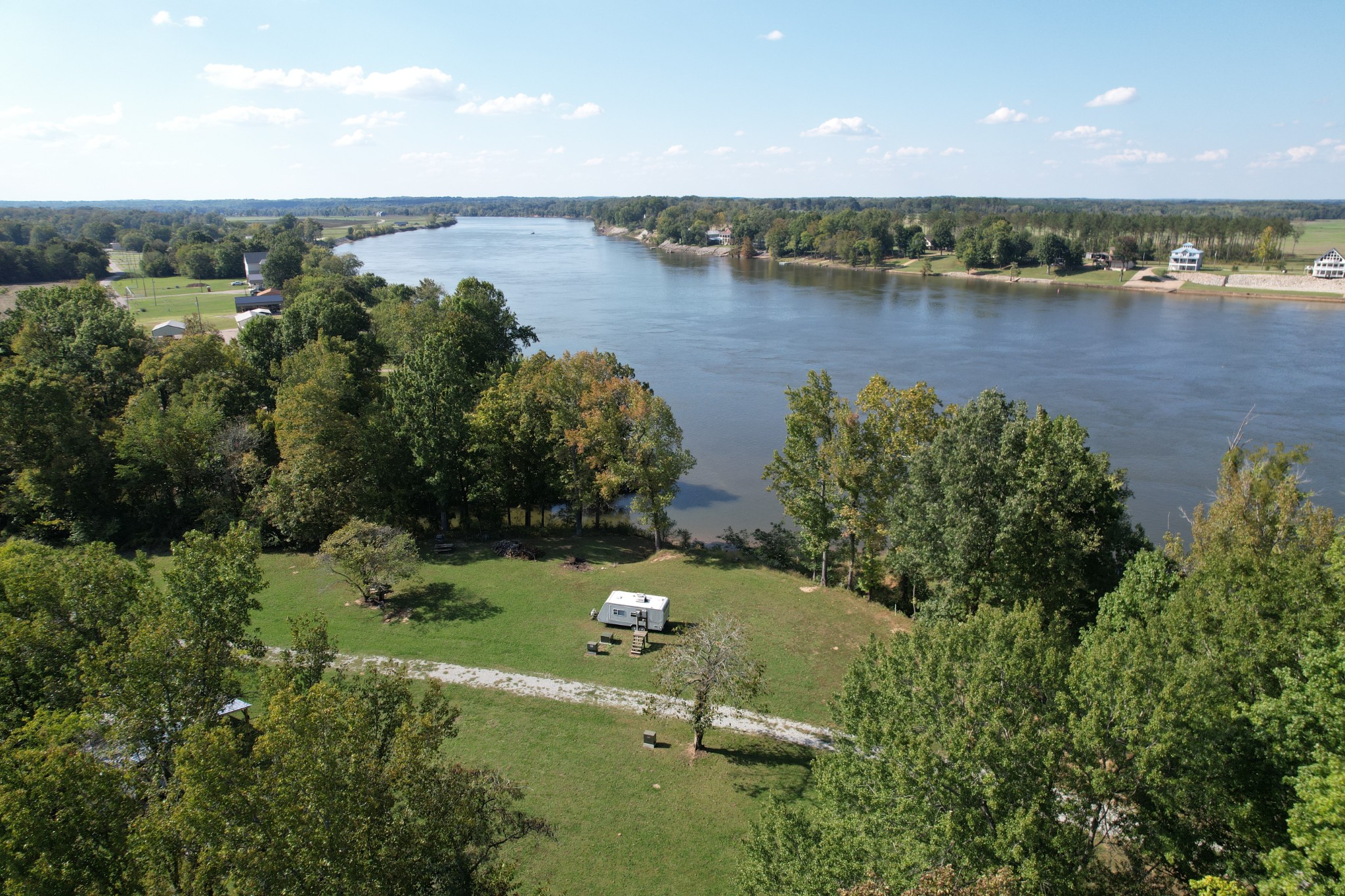 an aerial view of a houses with outdoor space and lake view