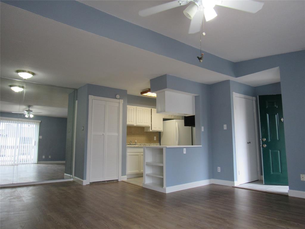 a view of a kitchen with wooden floor and a window