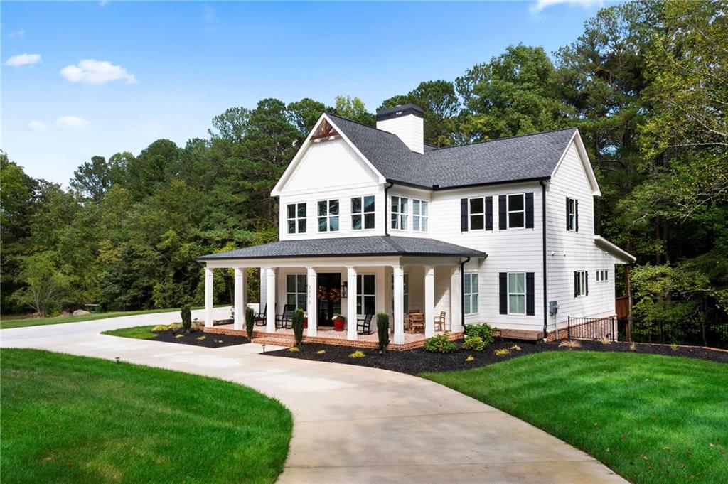 a front view of a house with yard and green space