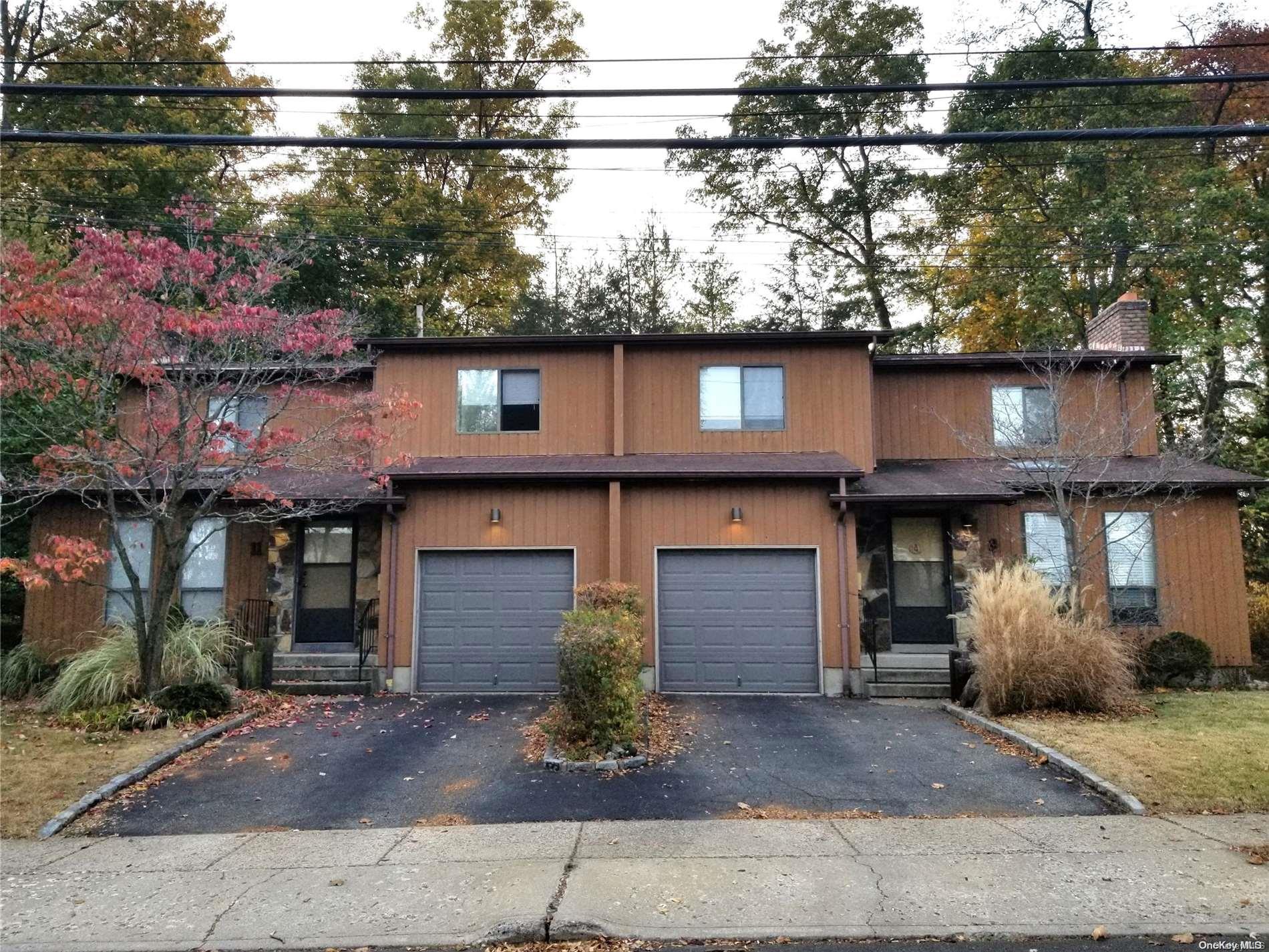 a front view of a house with a street