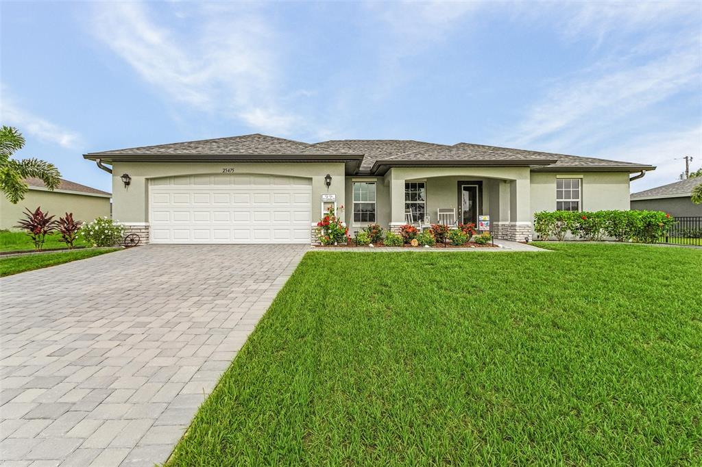 a front view of house with yard and green space