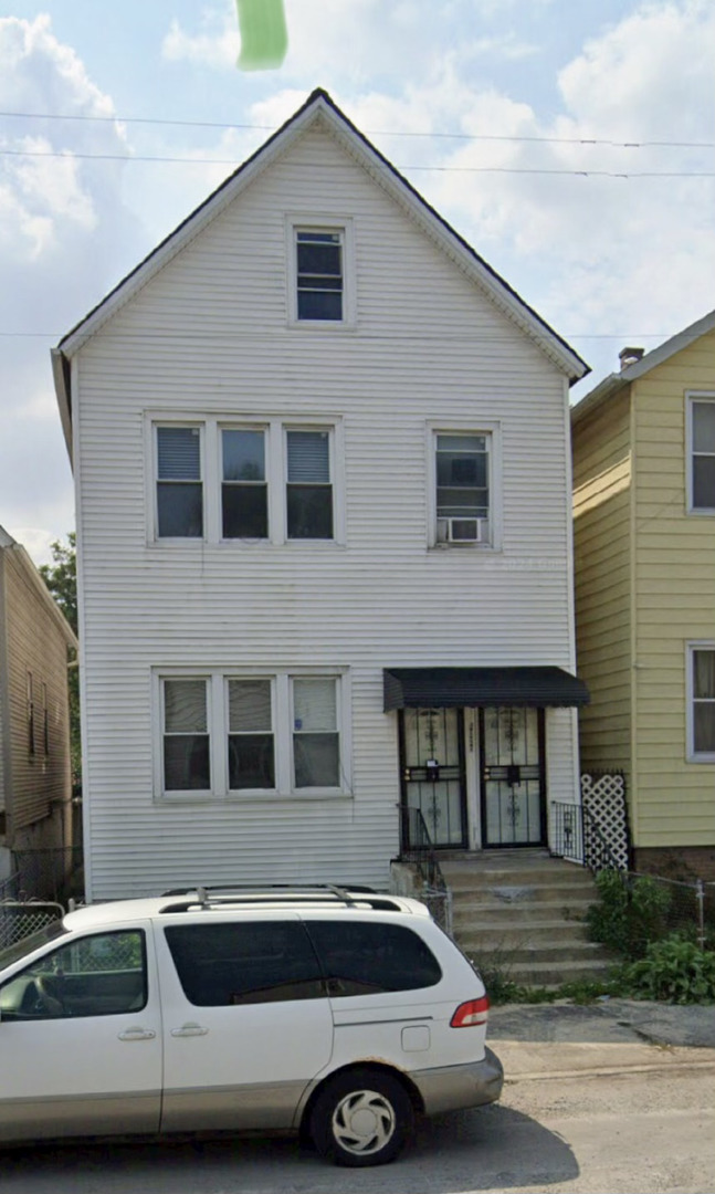 a front view of a house with parking space