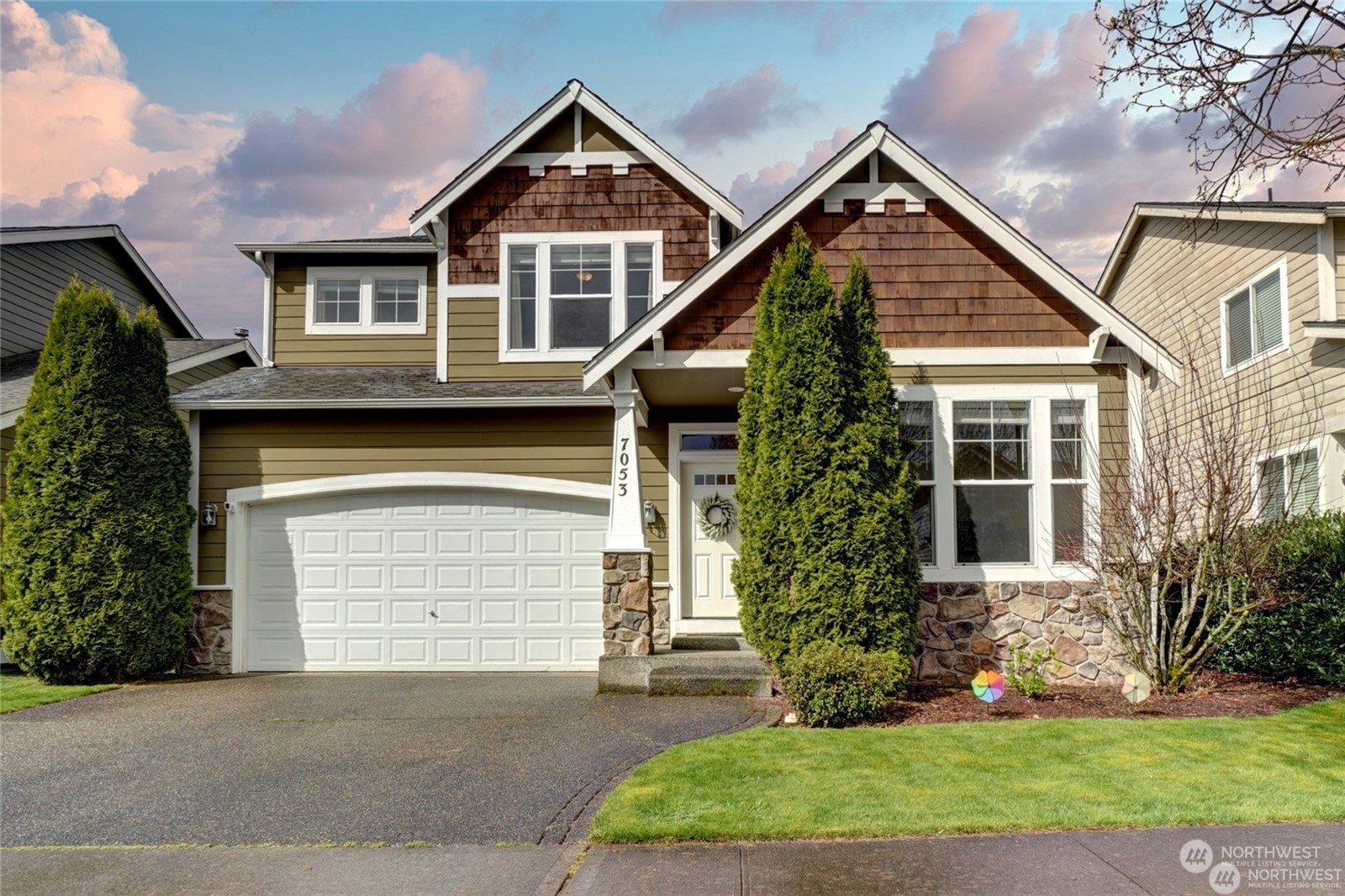 a front view of a house with a yard and garage