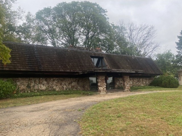 a front view of a house with a garden