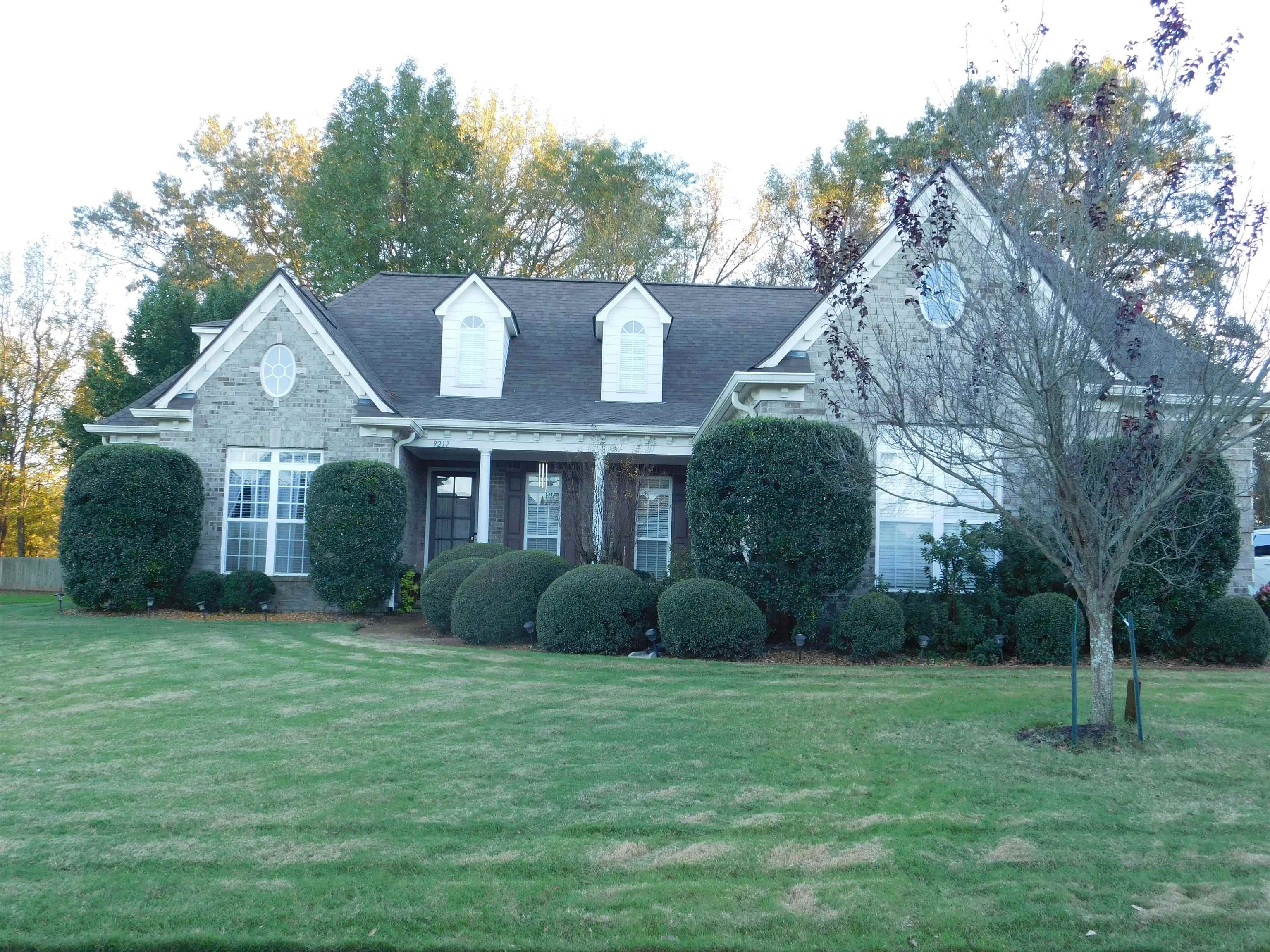 Front view of beautiful brick home with a manicured lawn!