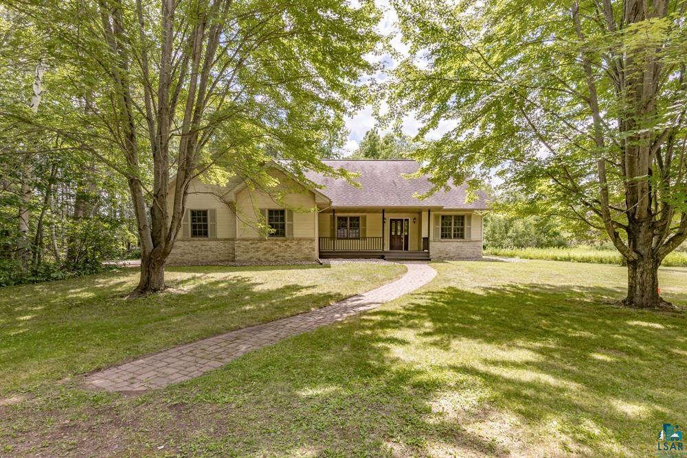 Ranch-style house featuring a porch and a front lawn