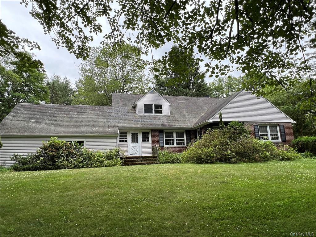 a aerial view of a house with a yard and potted plants