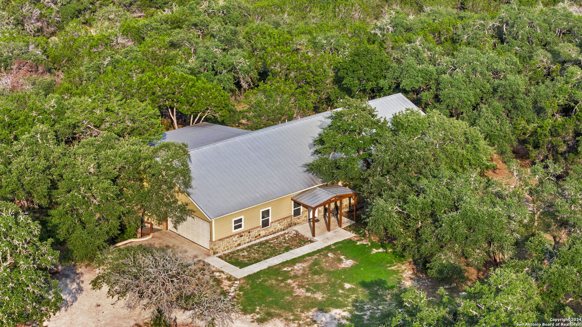 an aerial view of a house with a yard