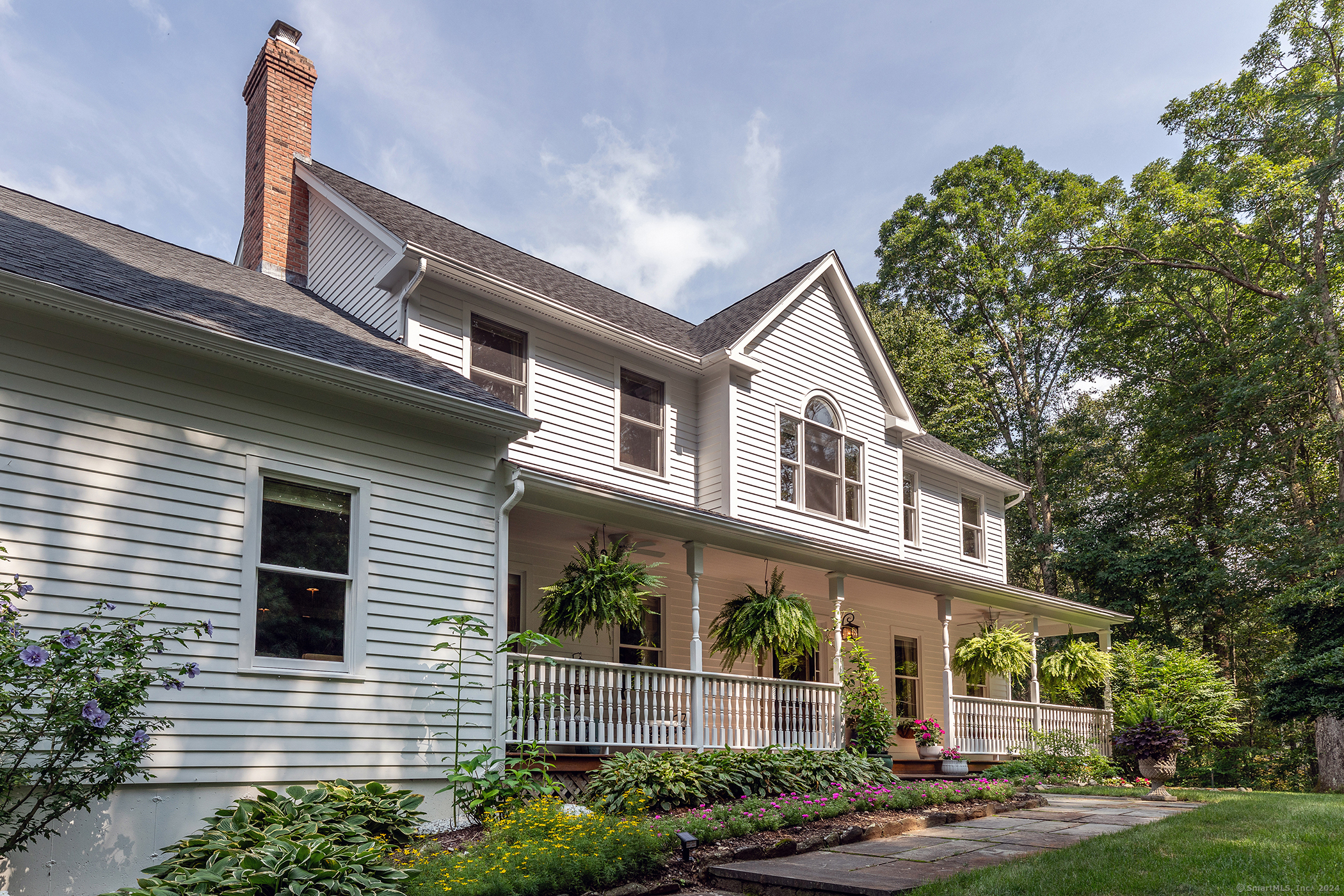 a front view of a house with a garden