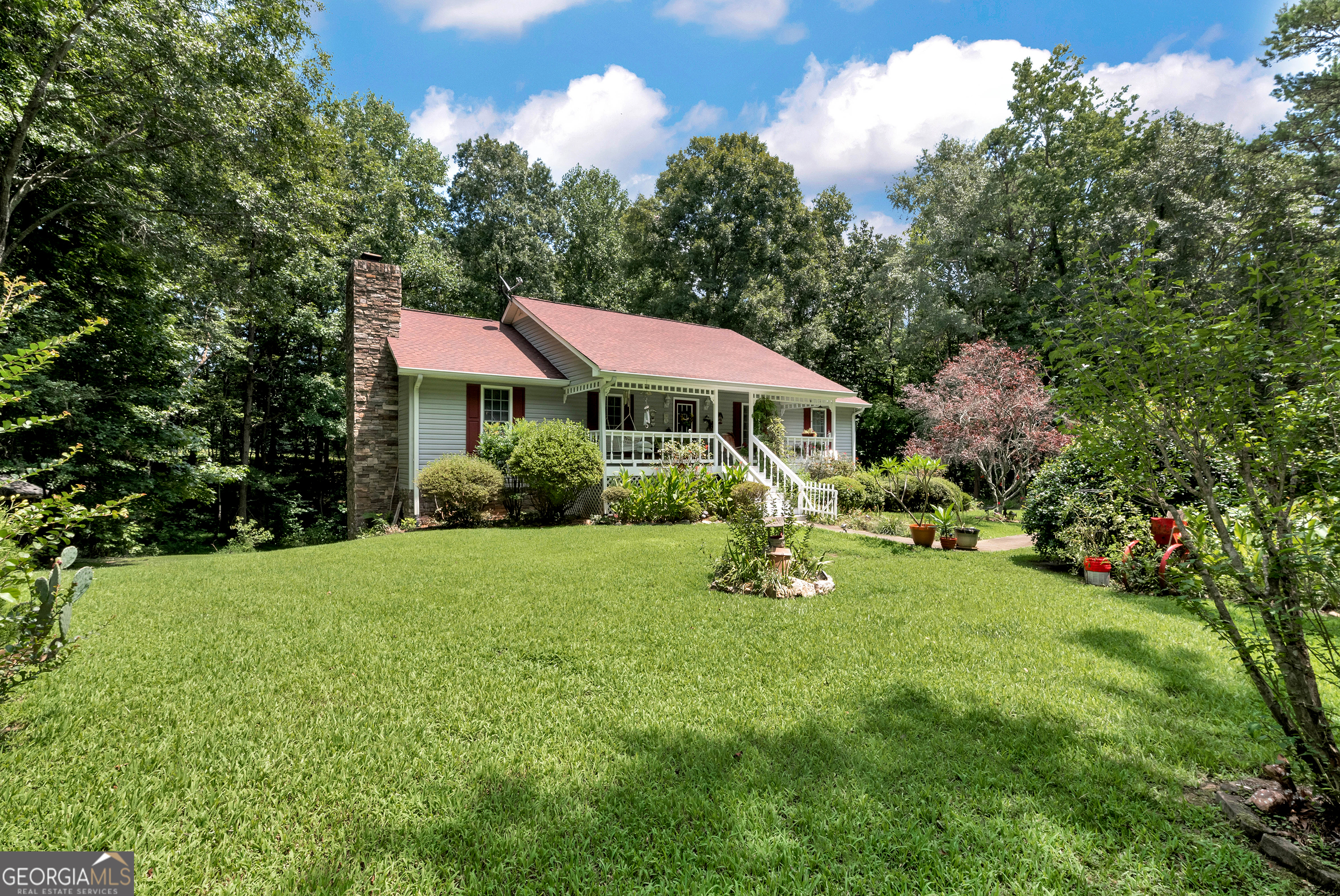 a view of a house with a yard and sitting area