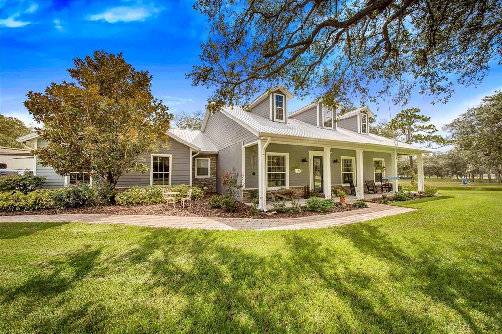 a view of a house with a yard patio and fire pit