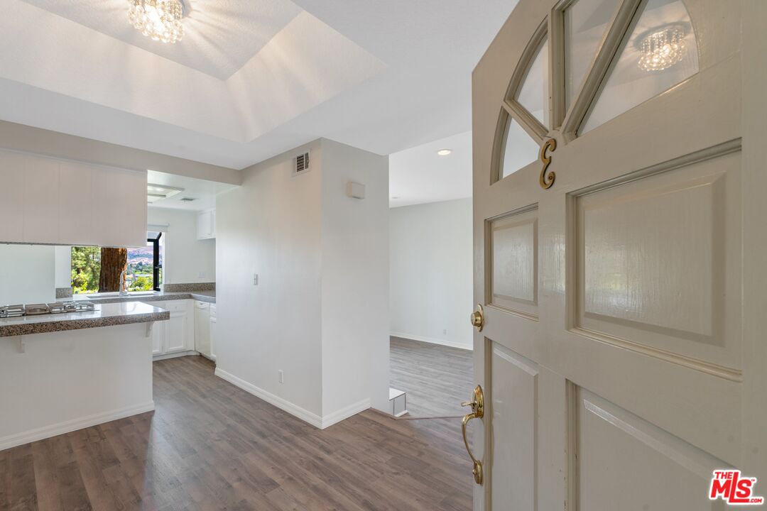 a kitchen with cabinets and wooden floor