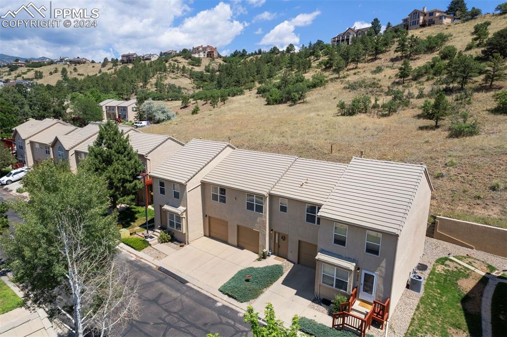 an aerial view of a house with a yard and balcony