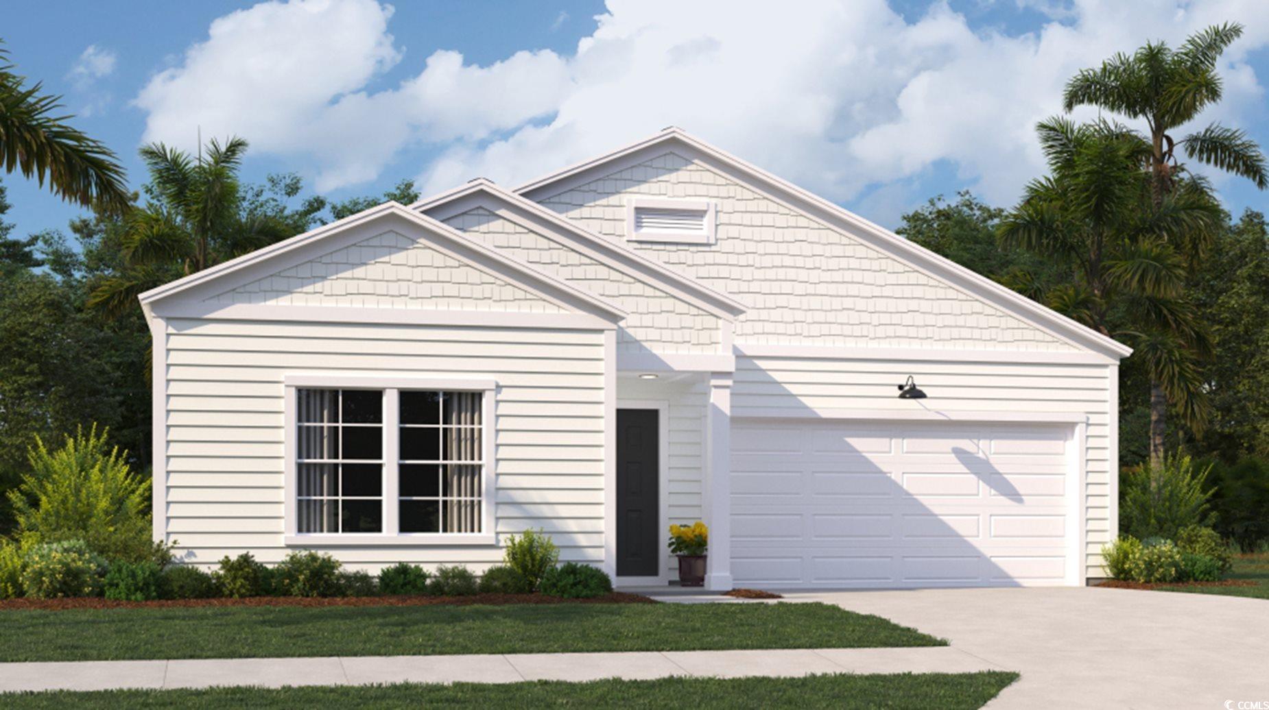 View of front of home with a front yard and a gara