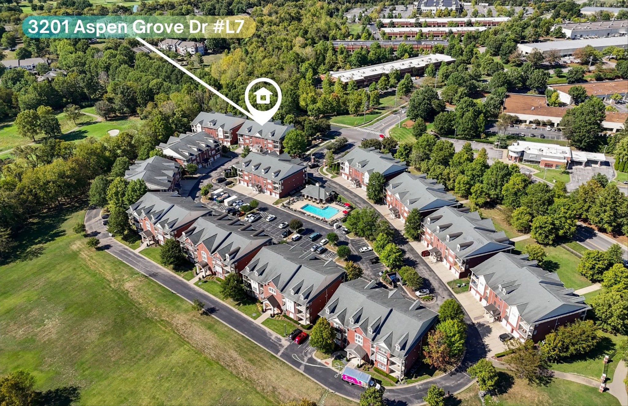 an aerial view of residential house and car parked on street side