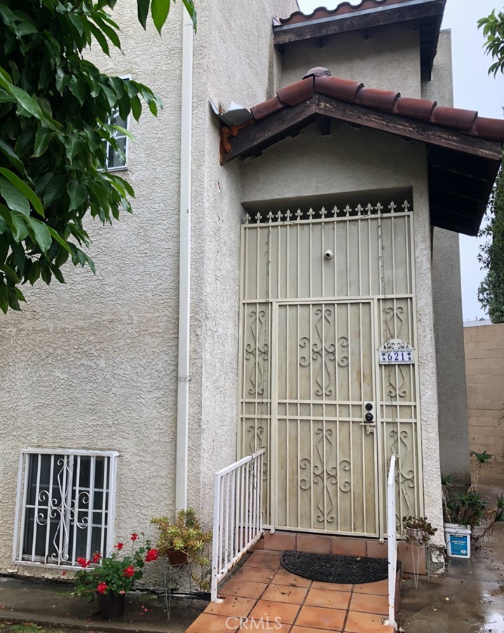 a view of a wooden door with a bench