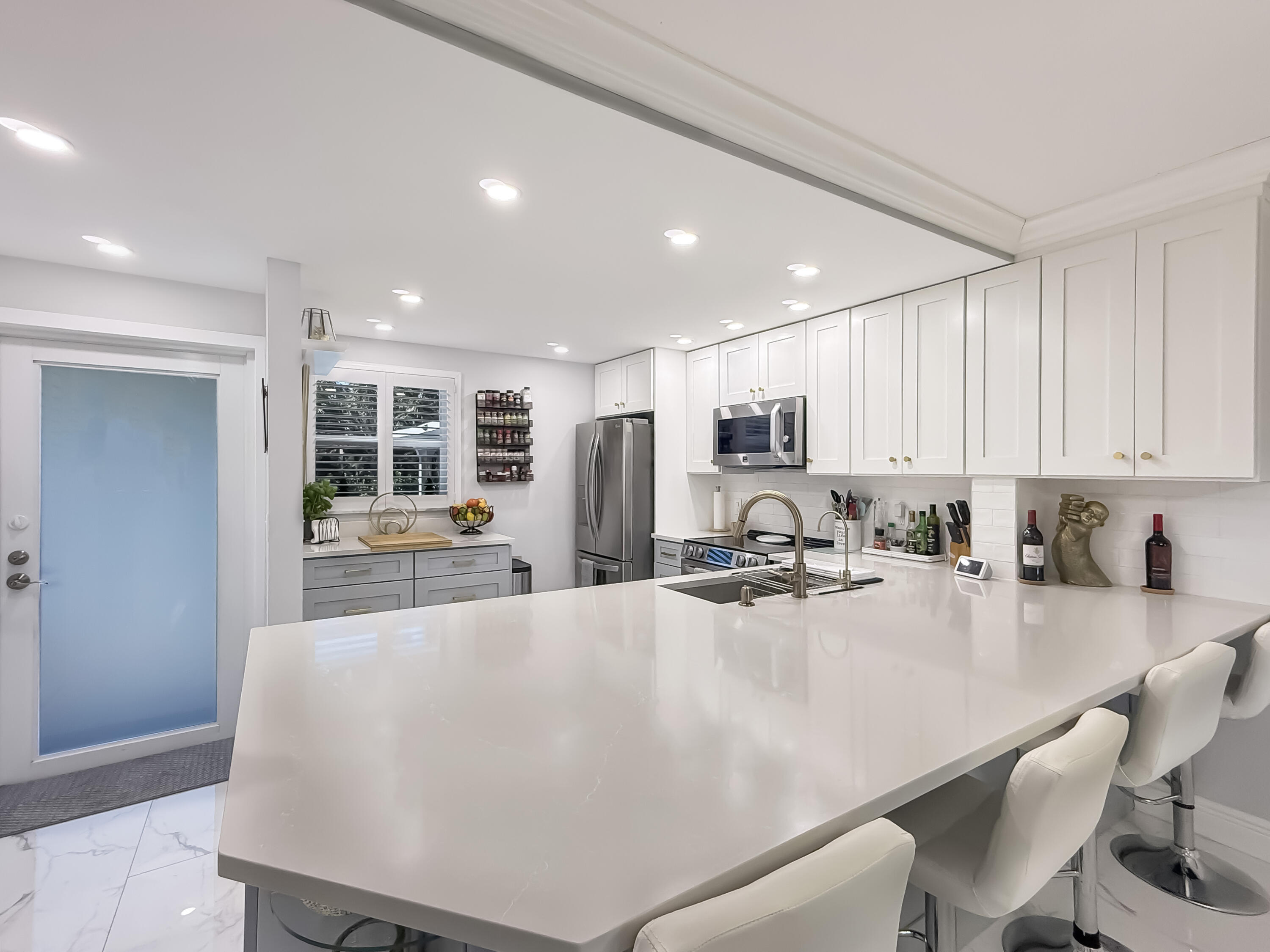 a large white kitchen with lots of counter space