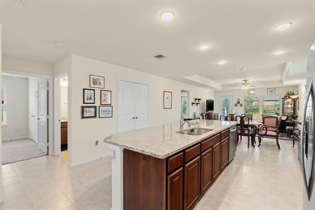 a living room with stainless steel appliances granite countertop furniture and a kitchen view