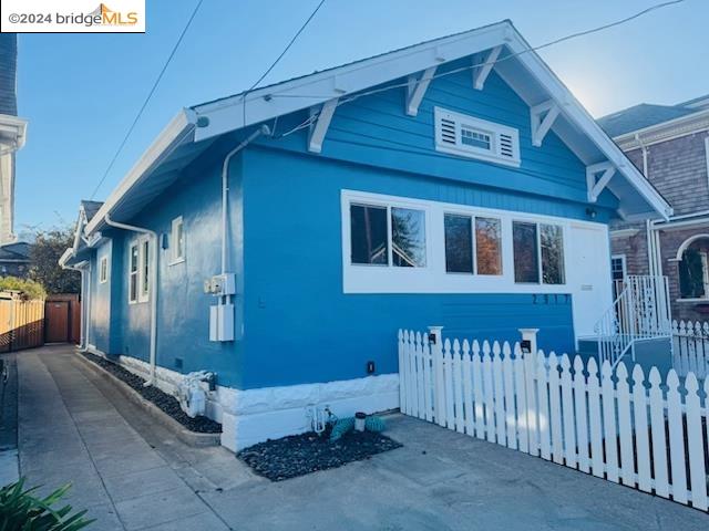 a view of a house with wooden fence