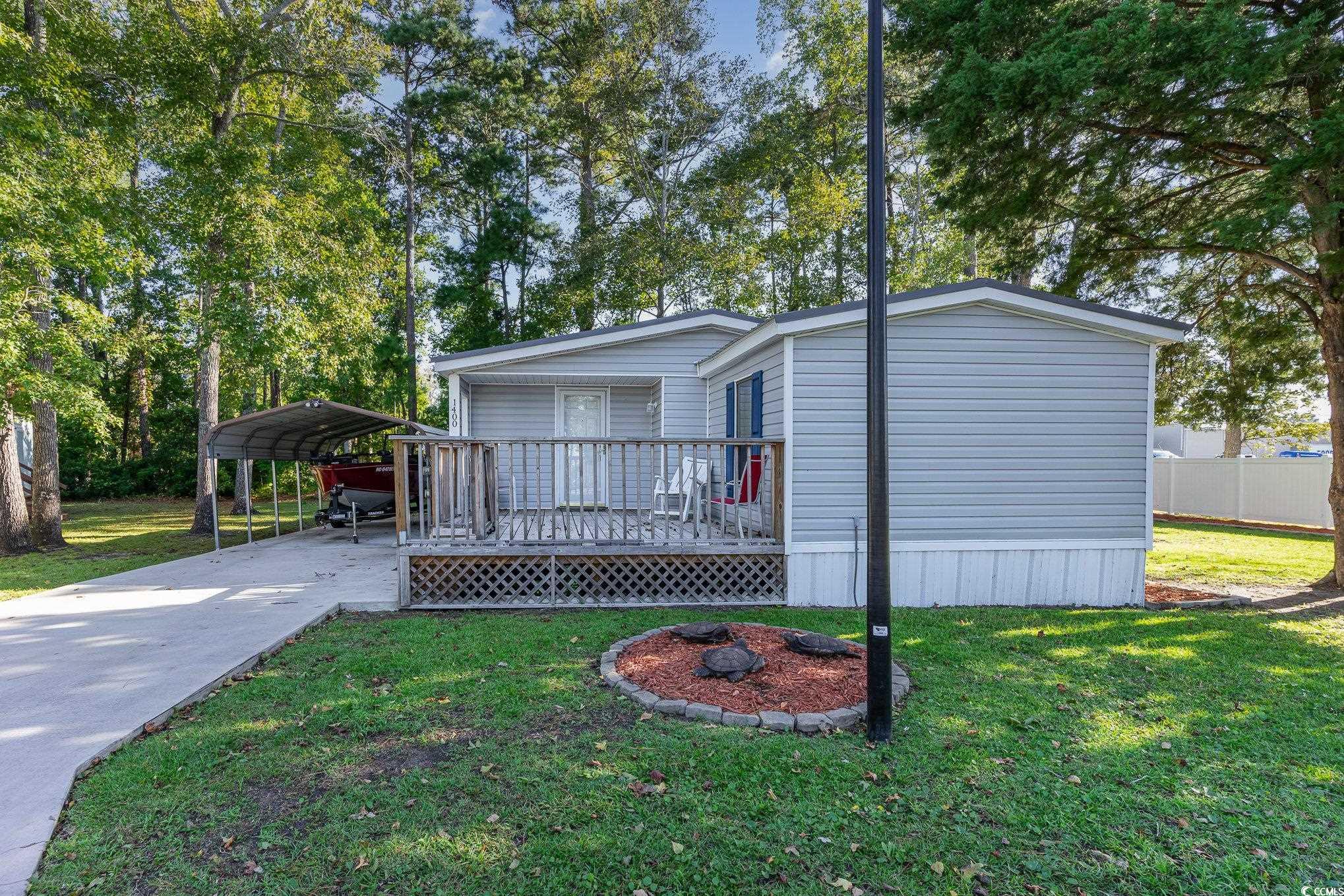 Manufactured / mobile home with a wooden deck, a f