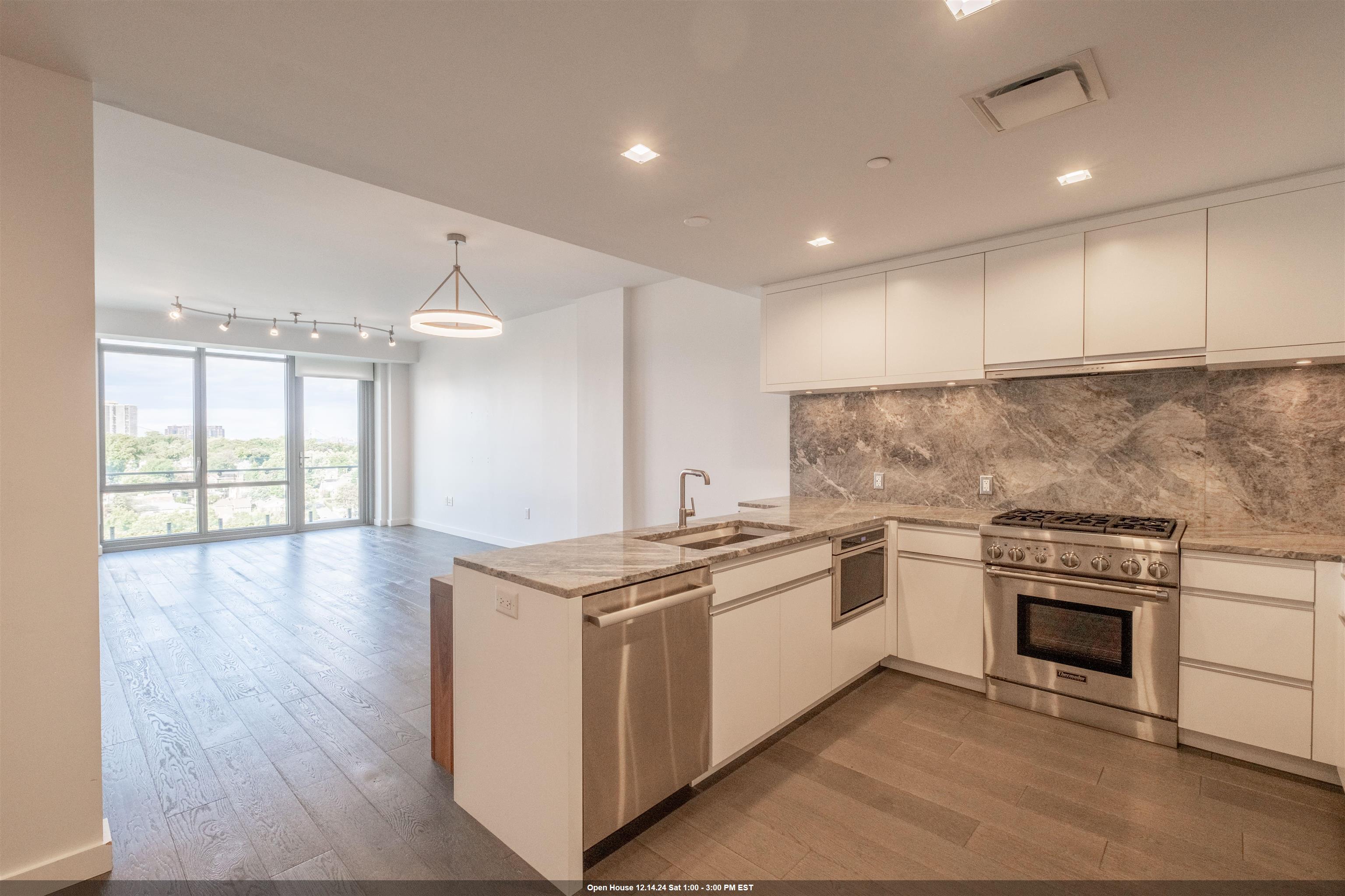 a kitchen with stainless steel appliances granite countertop a stove and a sink