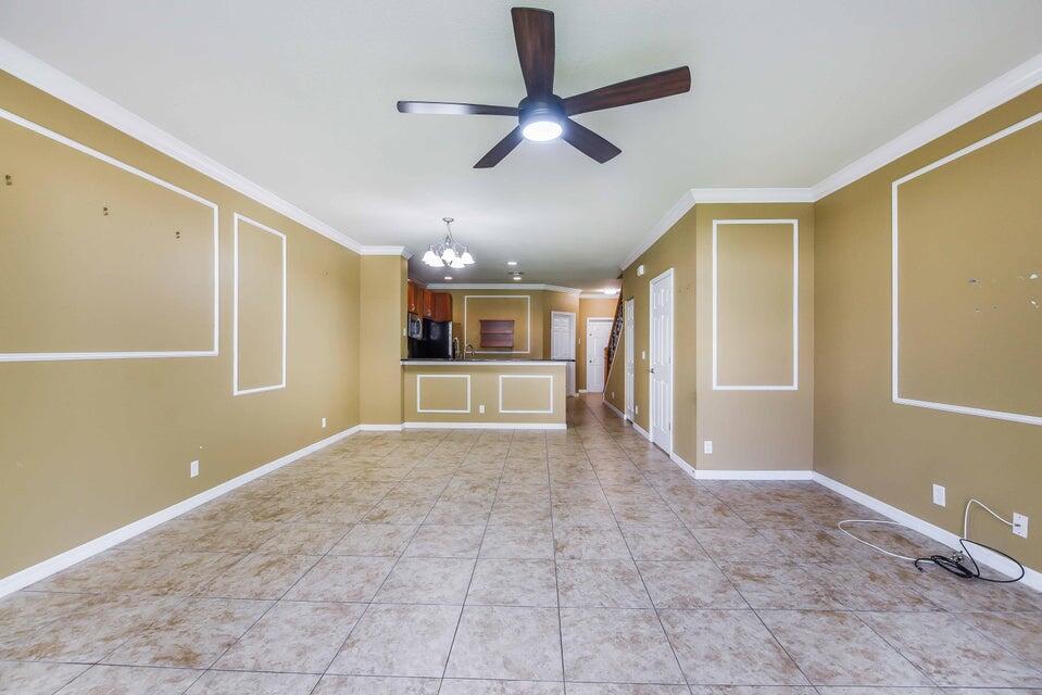 a view of a livingroom with a ceiling fan and window