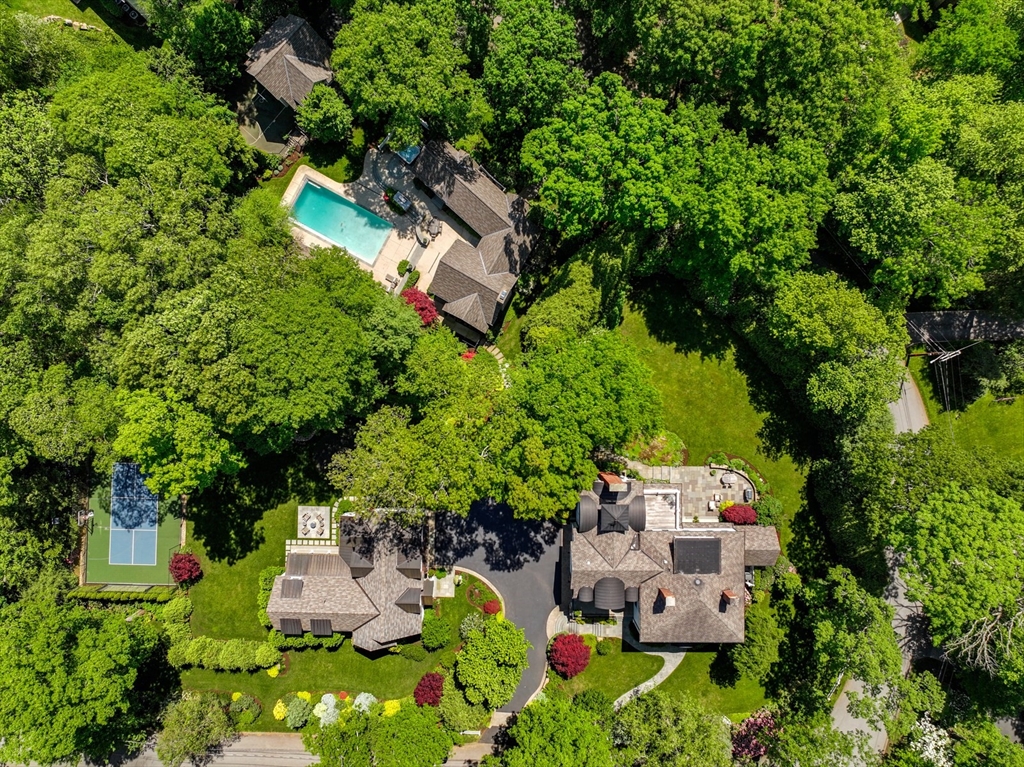 an aerial view of a house with a yard