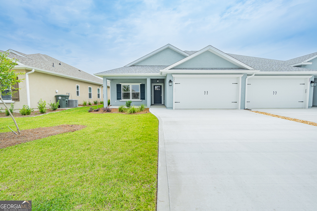 a view of a house with a yard and garage