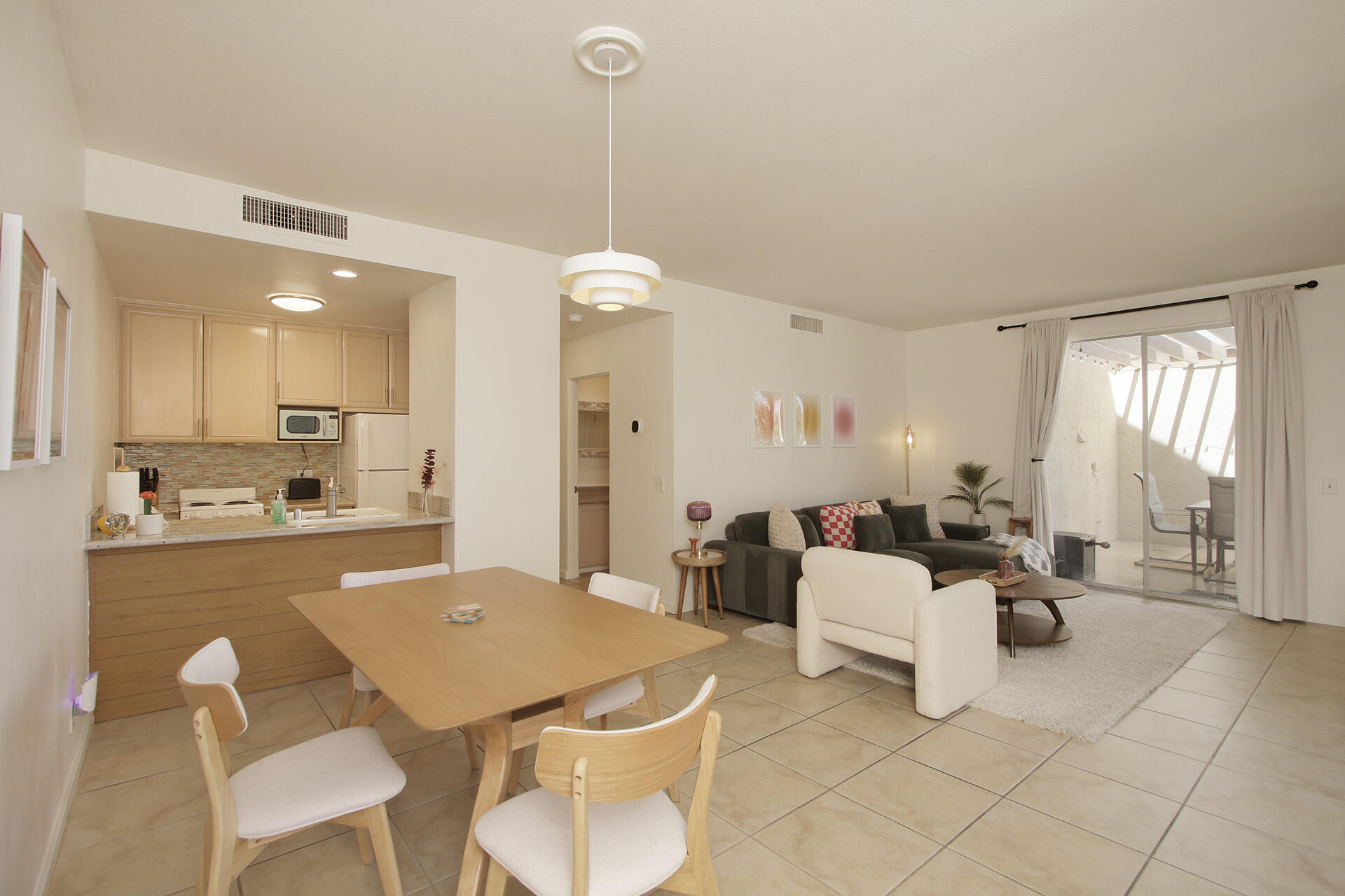 a living room with furniture a flat screen tv and a table