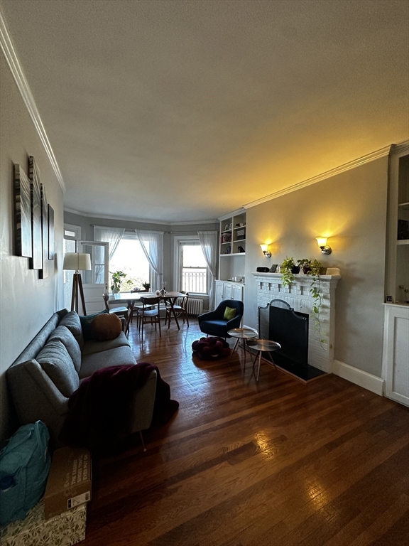 a living room with fireplace furniture and a fireplace