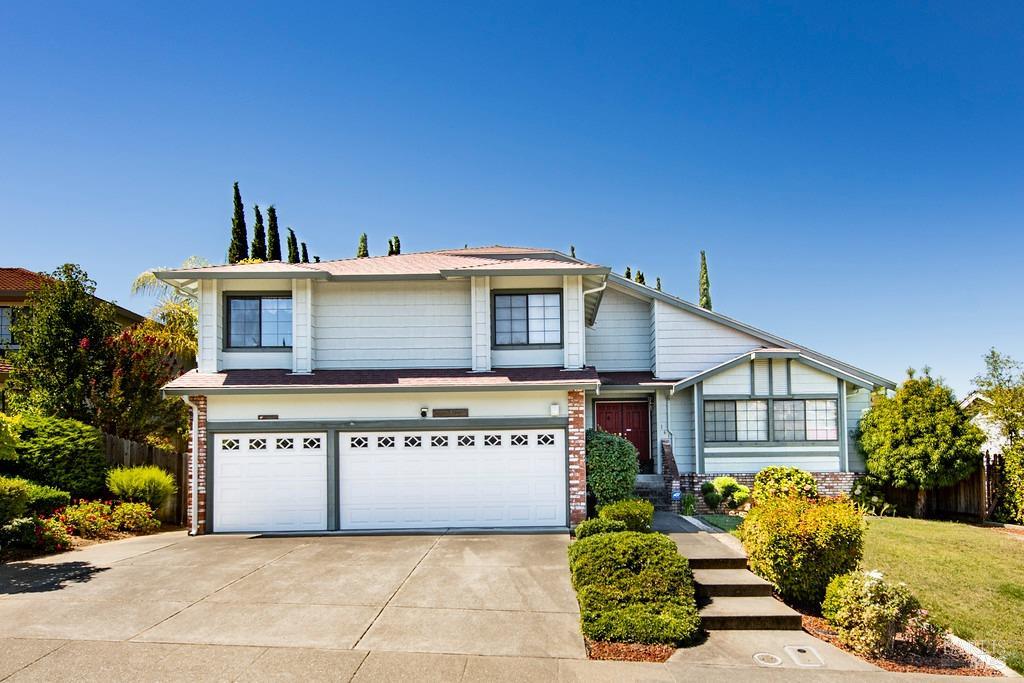 a front view of a house with a garden