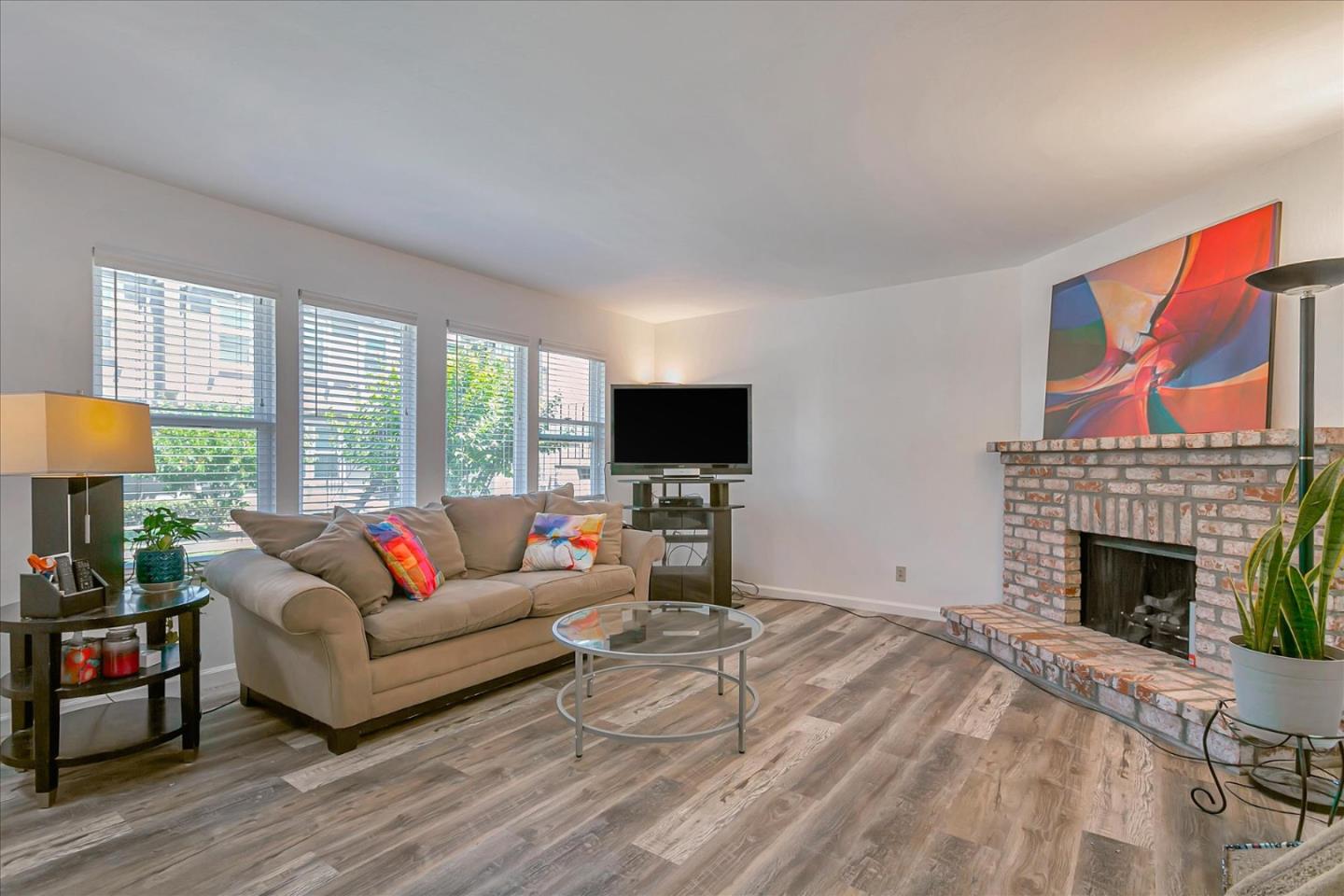 a living room with furniture a fireplace and a flat screen tv