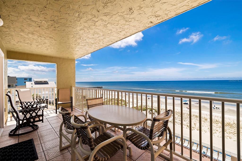 a view of a balcony with chairs