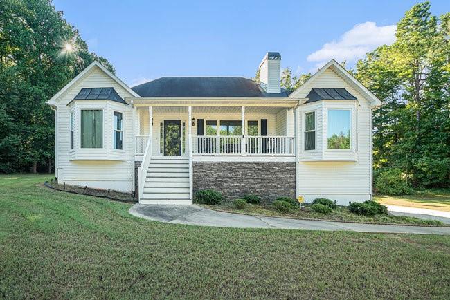 a front view of a house with a yard