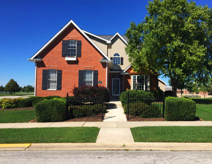 a front view of a house with a yard